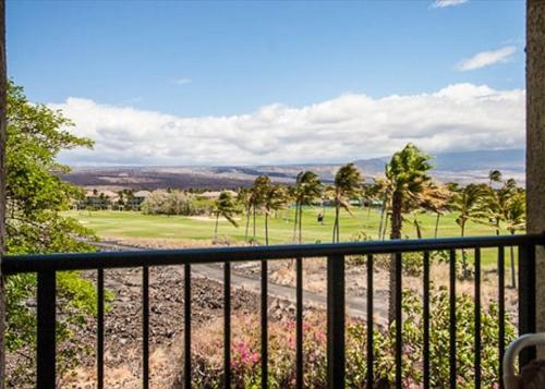 a balcony with a view of a golf course at Golf-view condo with golf discounts & lanai in Waikoloa