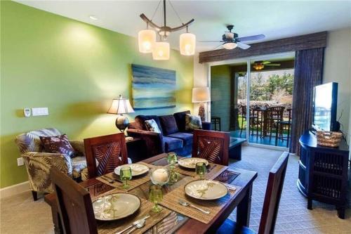 a living room with a dining table and a living room at Waikoloa condo with golf & ocean views in Waikoloa