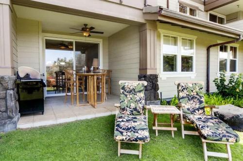 a patio with two chairs and a grill at Waikoloa condo with golf & ocean views in Waikoloa