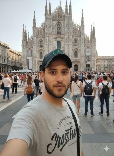 a man is standing in front of a cathedral at السنطه in Mīt al Layth