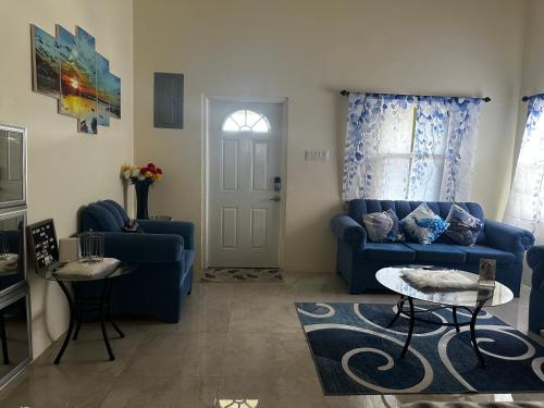 a living room with a blue couch and a table at Jepel's Escape in Florence Hall