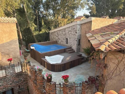 a patio with a bed and some plants and a building at Firenze en ValQuirico in Santeagueda