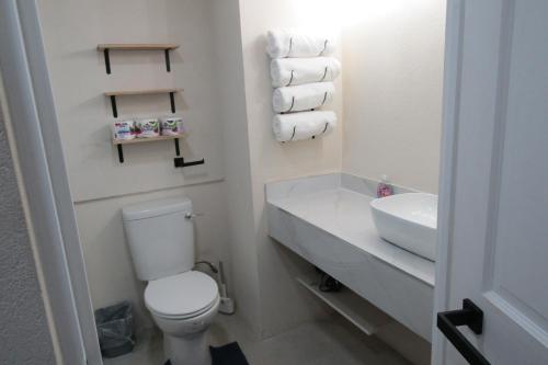 bagno con servizi igienici, lavandino e asciugamani. di 103 Batts Rock Beach Condo's a Saint Michael