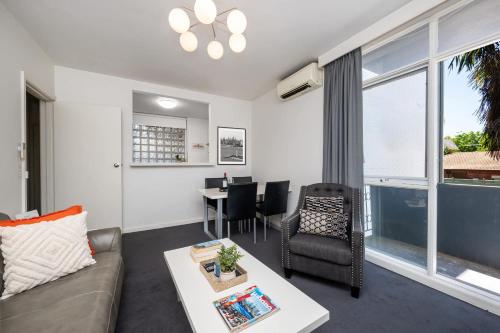 a living room with a couch and a table at 1 Bdrm With Parking, Walk to Beach in Melbourne