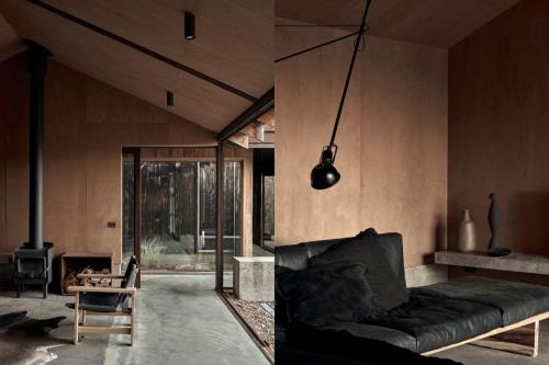 een woonkamer met een bank en een open haard bij Ross Farm - Dairy in Meeniyan