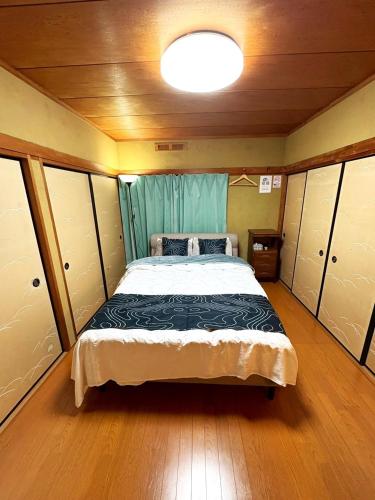 a bedroom with a large bed in a room at Nikko Central GOKO STAY in Nikko