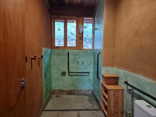 a bathroom with a shower and a window at Casa Solar in São Bento do Sapucaí