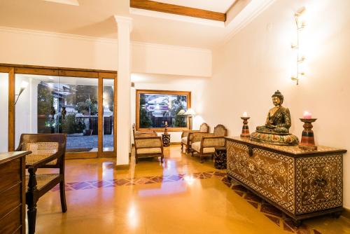 a living room with a statue on a table at Tissa's Inn in Cochin