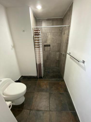 een badkamer met een toilet en een douche bij Costa Ayala - Bungalow 6 with 2dbl beds, 2 sofas in Los Ayala