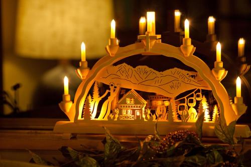 a candle holder with a picture of a house at Hotel Taigakukan in Hakuba