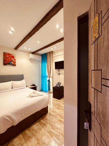 a bedroom with a white bed and a blue curtain at Giza Pyramids Inn in Cairo
