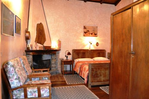 a bedroom with a bed and a fireplace at Chalet Su Foxile in Aritzo