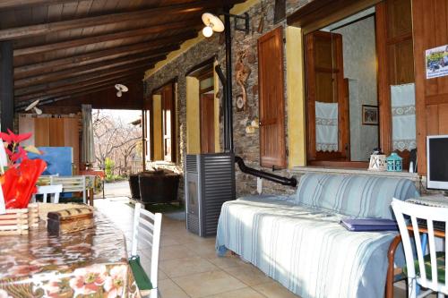 a bedroom with a bed and a table on a patio at Chalet Su Foxile in Aritzo