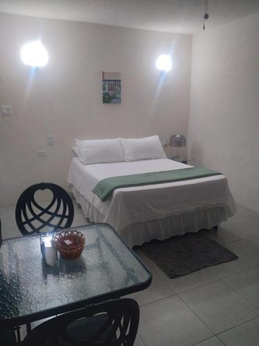 a bedroom with a bed and a table and lights at C'VAR Residential Vacation Apartment Rentals in Saint Michael