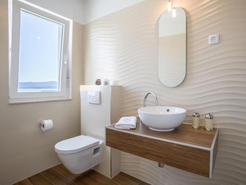 a bathroom with a sink and a toilet at Villa in Bol with swimming pool in Bol