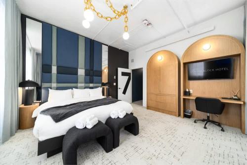 a bedroom with a large bed and a desk at Symons Block Suite 7 in Spokane