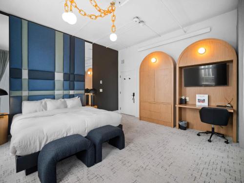 a bedroom with a large bed and a desk and chair at Symons Block Suite 7 in Spokane