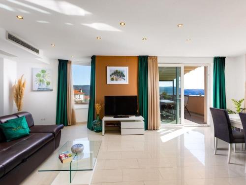 a living room with a couch and a television at Villa in Korni with swimming pool in Kornić