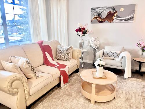 a living room with a couch and two chairs at Spacious & Comfy Upper Floor 3BR Suite in Detached House in Calgary