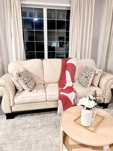 a living room with a couch and a table at Spacious & Comfy Upper Floor 3BR Suite in Detached House in Calgary