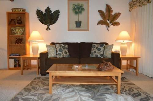 a living room with a couch and a coffee table at Peaceful golf retreat with shared pools in Waikoloa Village