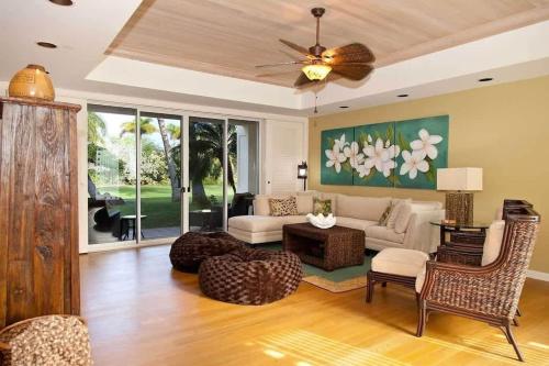 a living room with a couch and a table at Spacious retreat with pool & private lanai in Waikoloa