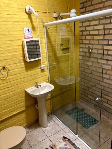 a bathroom with a glass shower and a sink at Casa Galeguita in Pipa