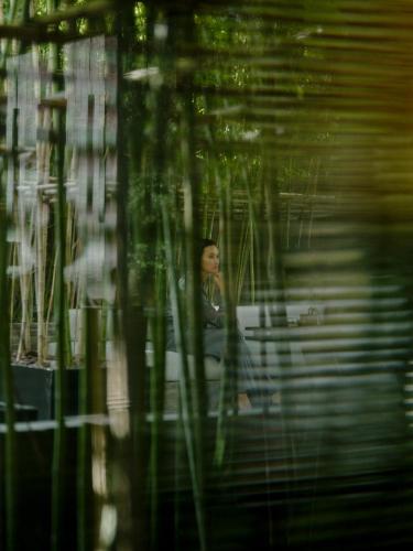 a woman sitting at a table in a room at The PuLi Shanghai in Shanghai
