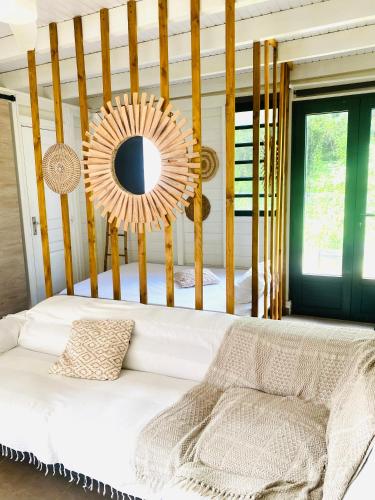 a room with a white couch and a mirror at Villa cactus in Goyave