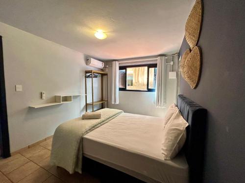 Ένα ή περισσότερα κρεβάτια σε δωμάτιο στο Pousada Recanto das Praias