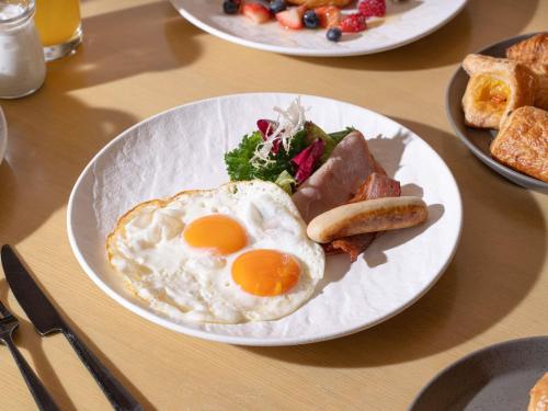 a plate of breakfast food with eggs and toast at AKI Hotel Hong Kong - MGallery Collection in Hong Kong