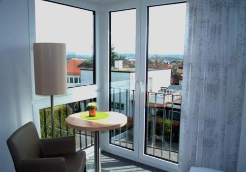a room with a large window with a table and a chair at AKZENT Hotel Altes Casino in Fulda