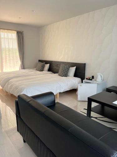 En eller flere senge i et værelse på ビジネス&長期ステイコテージ