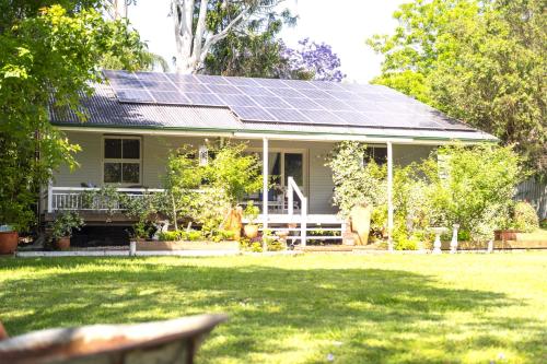 a house with solar panels on the roof at Celestial Dew Guesthouse in Tyalgum in Tyalgum