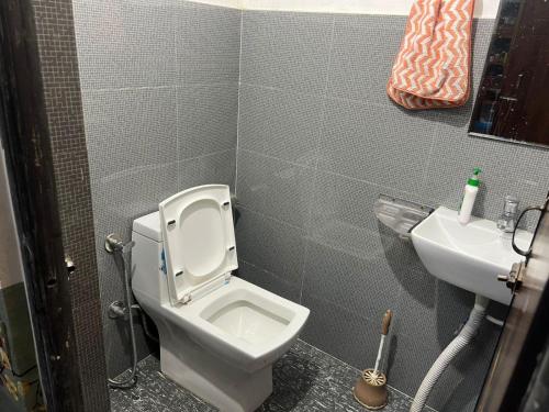 a small bathroom with a toilet and a sink at Maitreya Homestay in Tawang