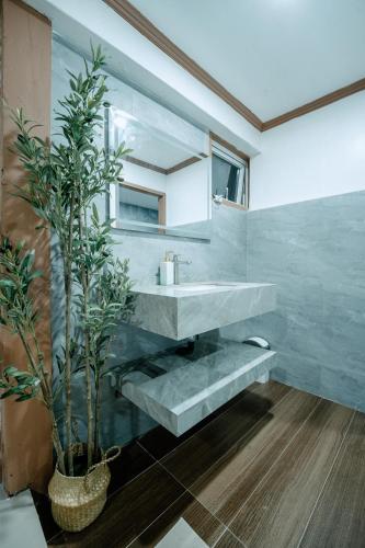 a bathroom with a sink and a mirror at Mia Bae Lodge in Coron