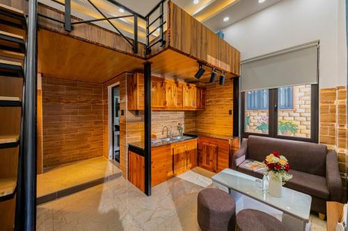 a living room with a couch and a table at Cherry Hotel 2 Da Lat in Da Lat