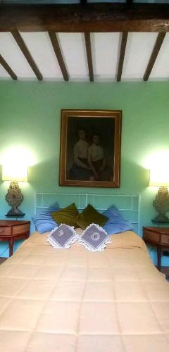 een slaapkamer met een bed met een schilderij aan de muur bij Vita Toscana Guest House in Chiusi