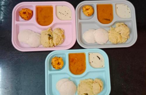 two plastic containers filled with different types of food at The Dreams sea view in Puducherry