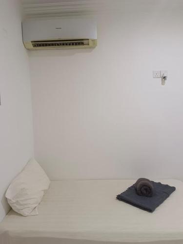a bed with a towel and a roll of paper at Nordic Residences in Malacca