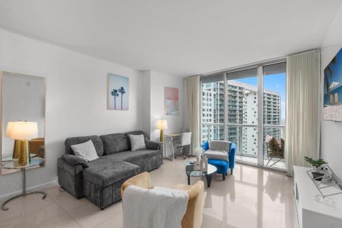 a living room with a couch and a table at Brickell 35th Floor Residence with Saltwater Pool 5-Star Amenities in Miami