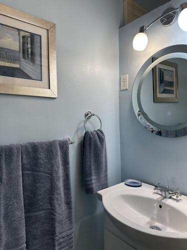 a bathroom with a sink and a mirror at BellaDonna By The Bay in Bridgetown