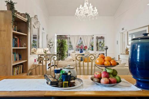 a table with two bowls of fruit on top of it at Celestial Dew Guesthouse in Tyalgum in Tyalgum