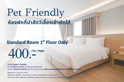 a poster of a bed in a hotel room at The Kite Hotel Bangsaen by Koko in Ban Laem Thaen