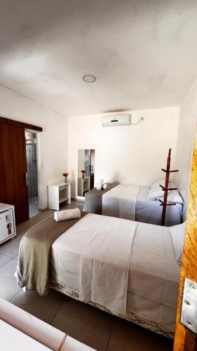 a bedroom with two beds in a room at Pousada e restaurante trilha da capivara in Coronel José Diaz