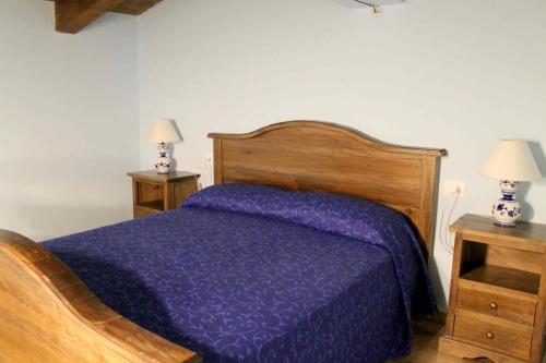 a bedroom with a purple bed with two night stands at Nonno Domenico in Sassano