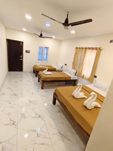 a room with four beds in it with a marble floor at VISAI Retreat in Tiruvannāmalai