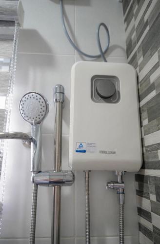 a hair dryer and other tools in a bathroom at Max n Fe in Iriga City