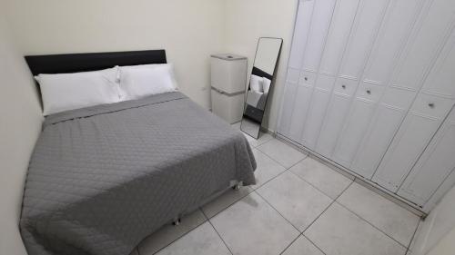 a bedroom with a bed and a mirror in it at La Casa de Miranda in San Miguel