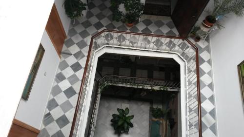 a mirror in a room with a checkered wall at Hostal Centro Sol in Cádiz